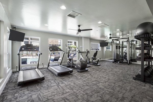 State-of-the-art fitness center at Woodland Trails Apartments equipped with modern exercise machines and free weights for a comprehensive workout