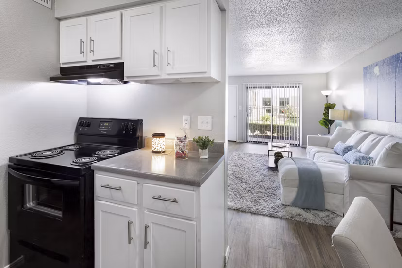 Contemporary kitchen with sleek countertops and stainless steel appliances at Woodland Trails Apartments