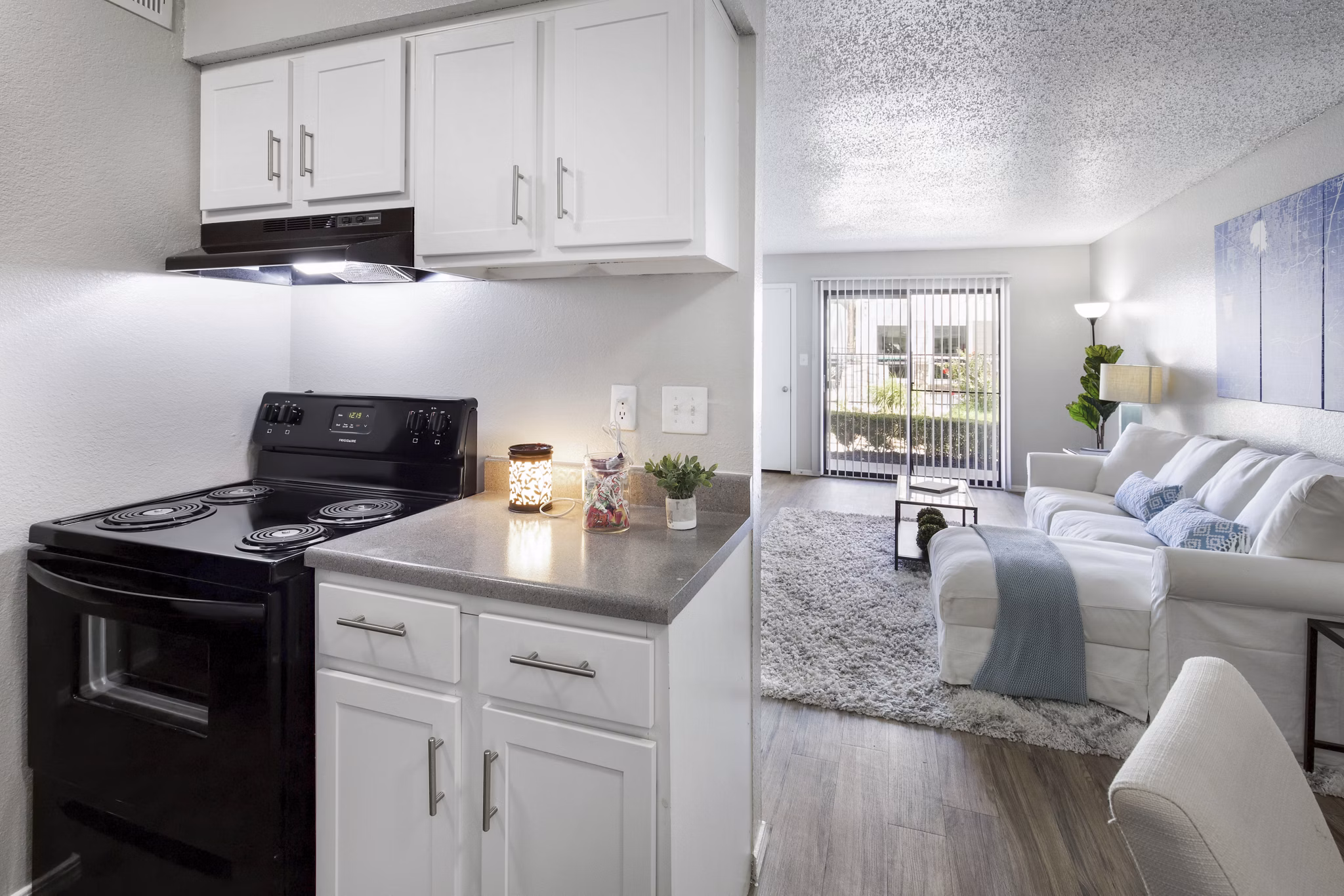Contemporary kitchen with sleek countertops and stainless steel appliances at Woodland Trails Apartments