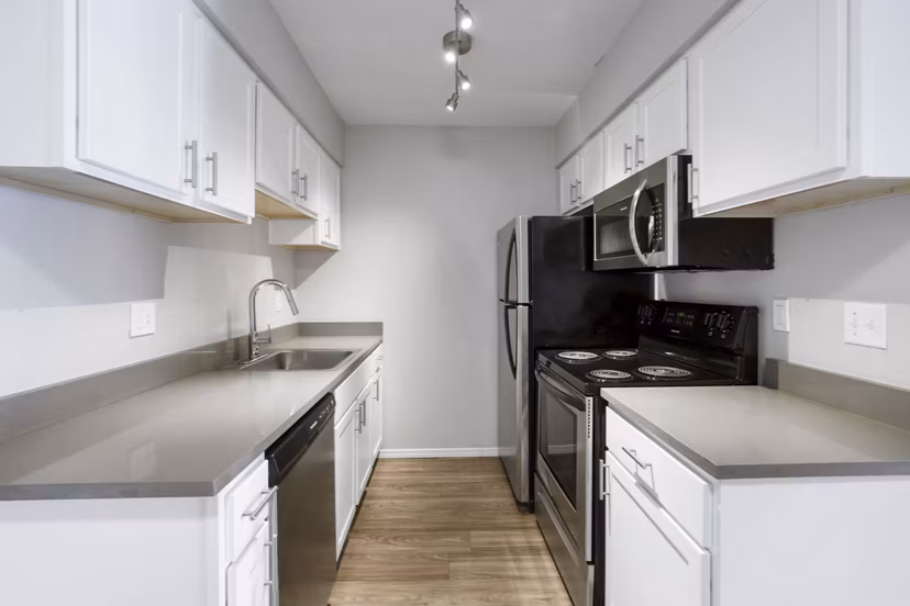 Modern kitchen with stainless steel appliances at Woodland Trails Apartments