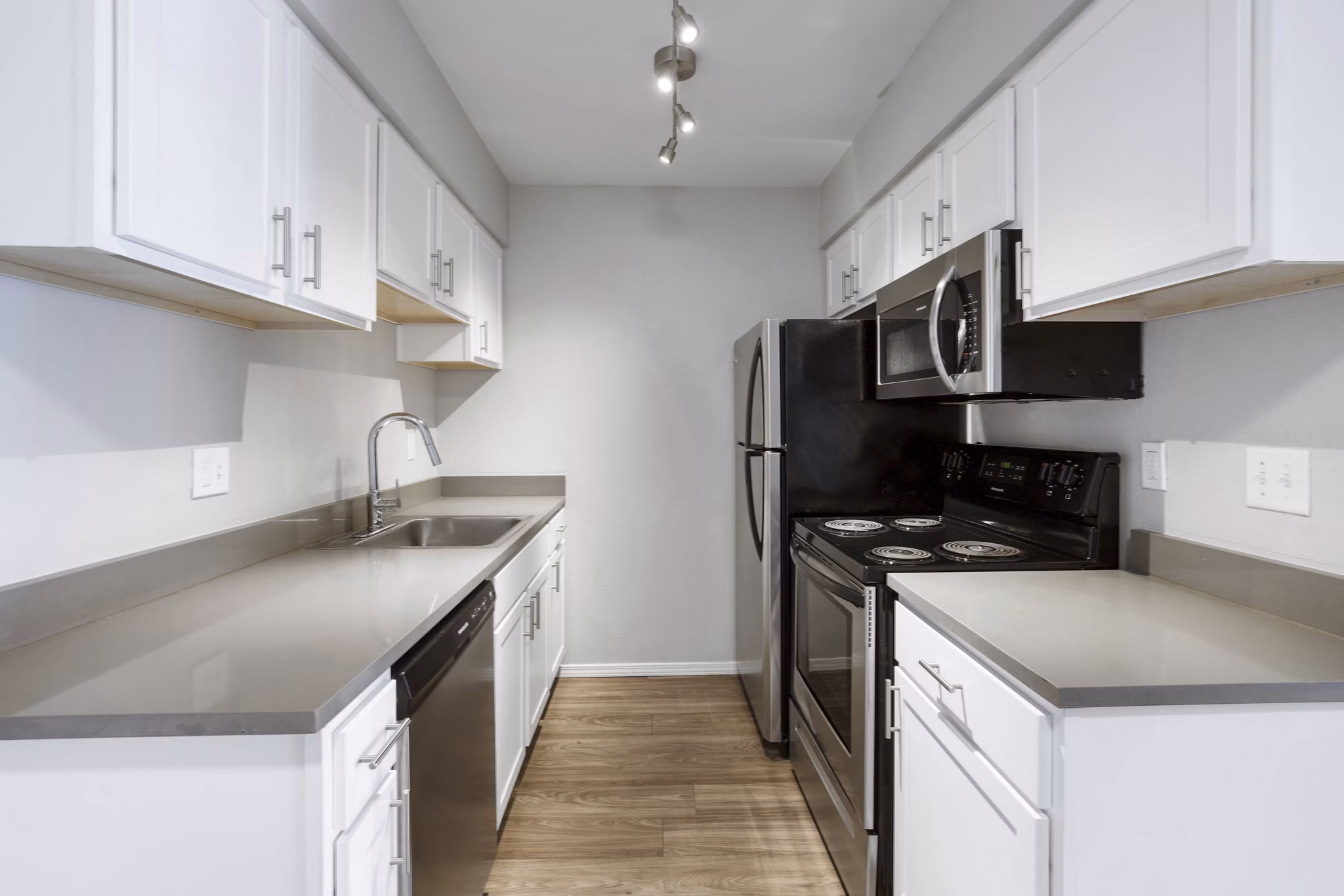 Modern kitchen with stainless steel appliances at Woodland Trails Apartments