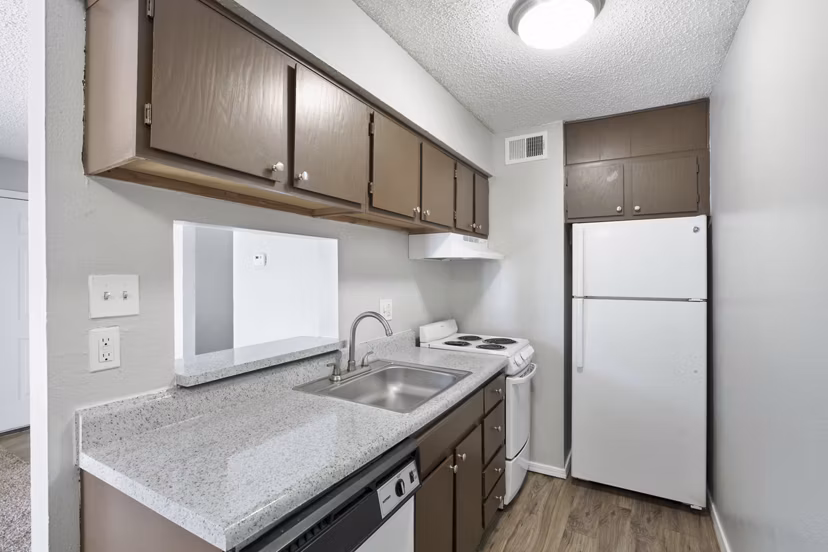 Modern kitchen with stainless steel appliances at Woodland Trails Apartments
