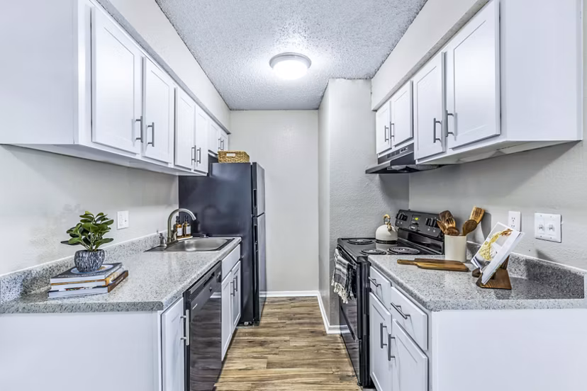 Modern kitchen with stainless steel appliances at Woodland Trails Apartments