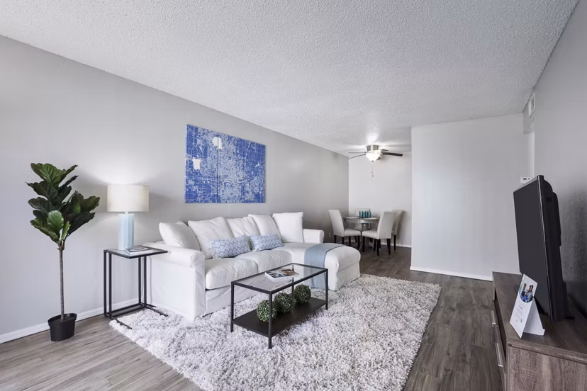 Modern living room with plush seating and natural light at Woodland Trails Apartments