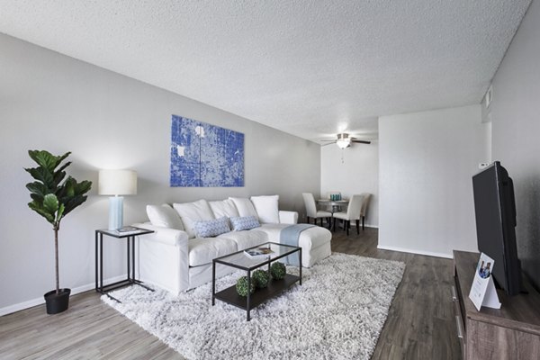 Modern living room with plush seating and natural light at Woodland Trails Apartments