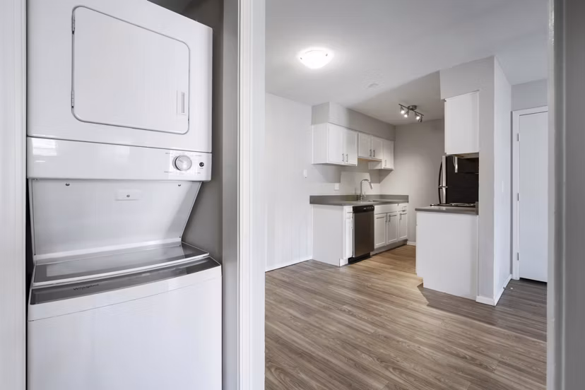 Laundry room featuring modern washers and dryers at Woodland Trails Apartments: Convenient amenities in luxury community