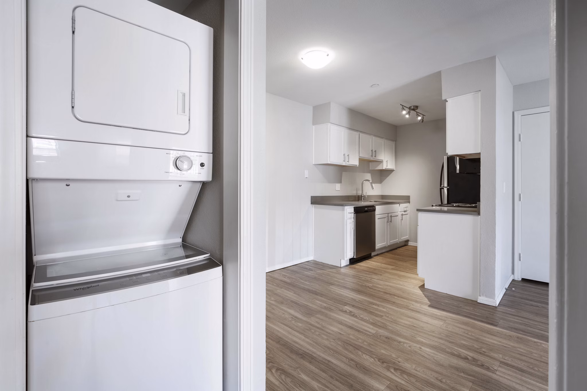Laundry room featuring modern washers and dryers at Woodland Trails Apartments: Convenient amenities in luxury community