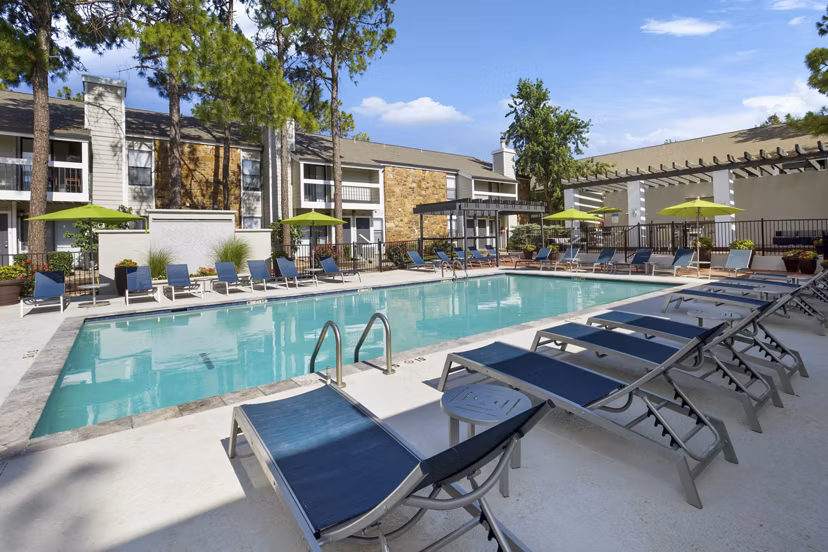 Luxury pool area at Woodland Trails Apartments offering a serene outdoor oasis perfect for relaxation and recreation in a stylish setting
