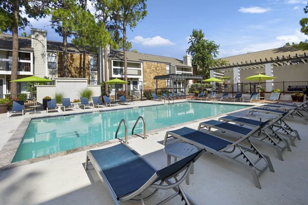 Luxury pool area at Woodland Trails Apartments offering a serene outdoor oasis perfect for relaxation and recreation in a stylish setting