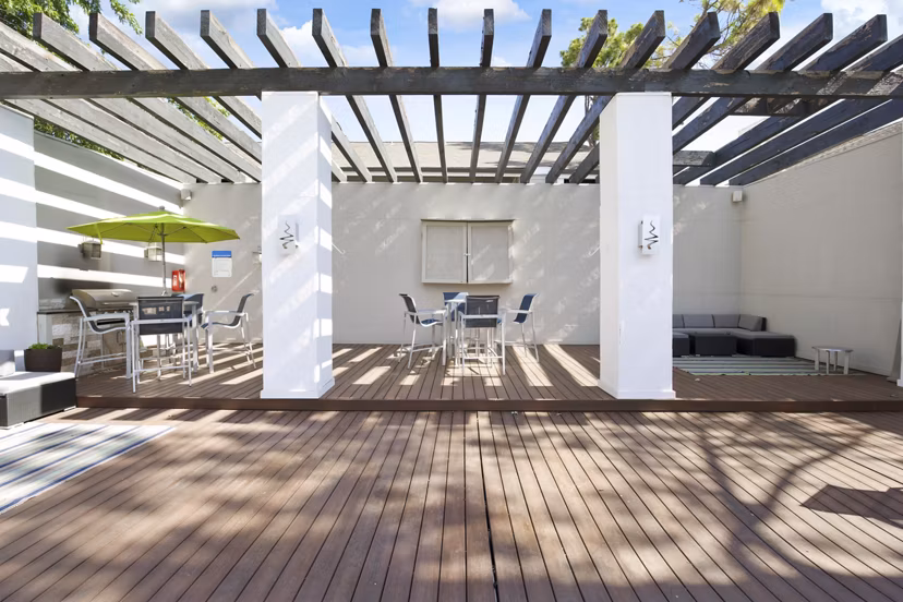 Spacious grill area with modern seating at Woodland Trails Apartments, perfect for outdoor dining and relaxation
