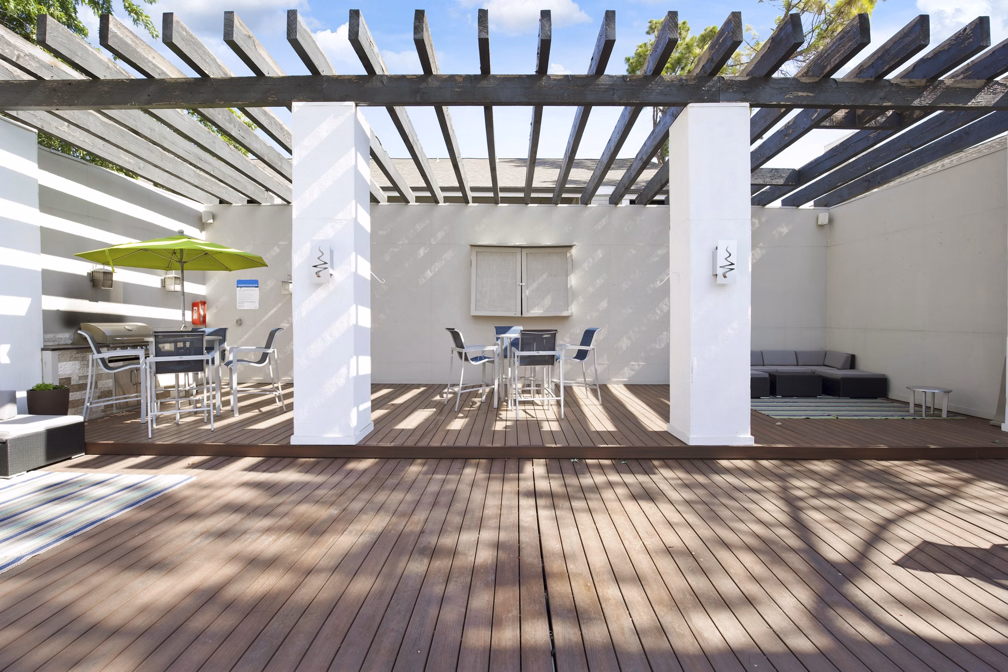 Spacious grill area with modern seating at Woodland Trails Apartments, perfect for outdoor dining and relaxation