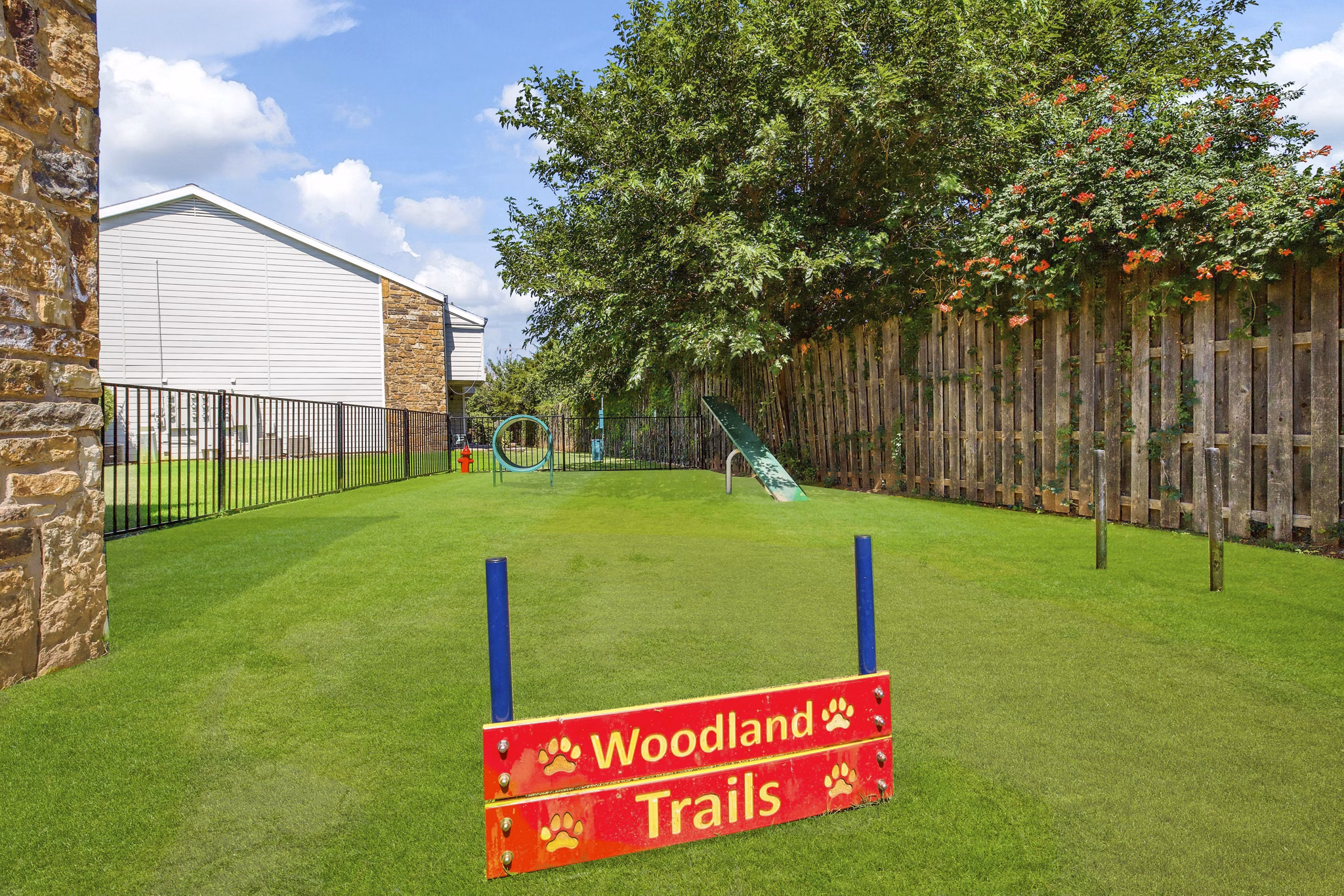 Dog park with agility equipment at Woodland Trails Apartments