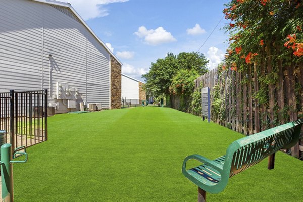 Dog park featuring agility equipment at Woodland Trails Apartments
