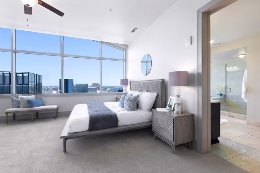 Elegant bedroom with modern decor and natural light at Ashton Austin Apartments in the heart of luxury living