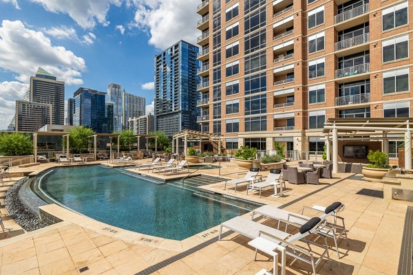Resort-style pool with lounge chairs at Ashton Austin Apartments offers luxury living in Austin