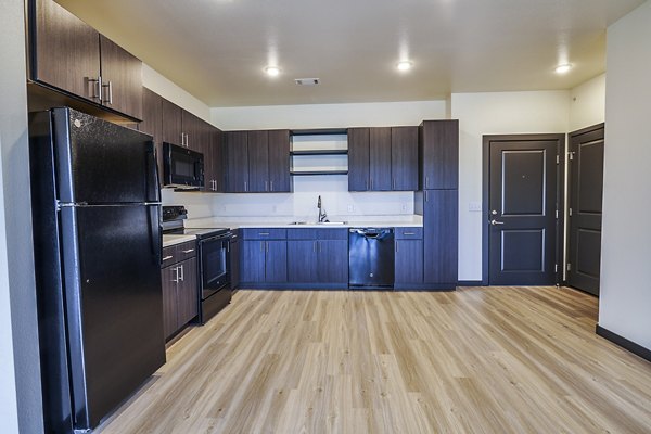Modern kitchen featuring sleek countertops and stainless steel appliances in Westbury Apartments