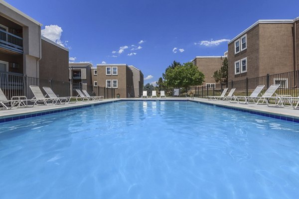Outdoor pool surrounded by lush landscaping at Westbury Apartments luxury community, perfect for relaxation and recreation