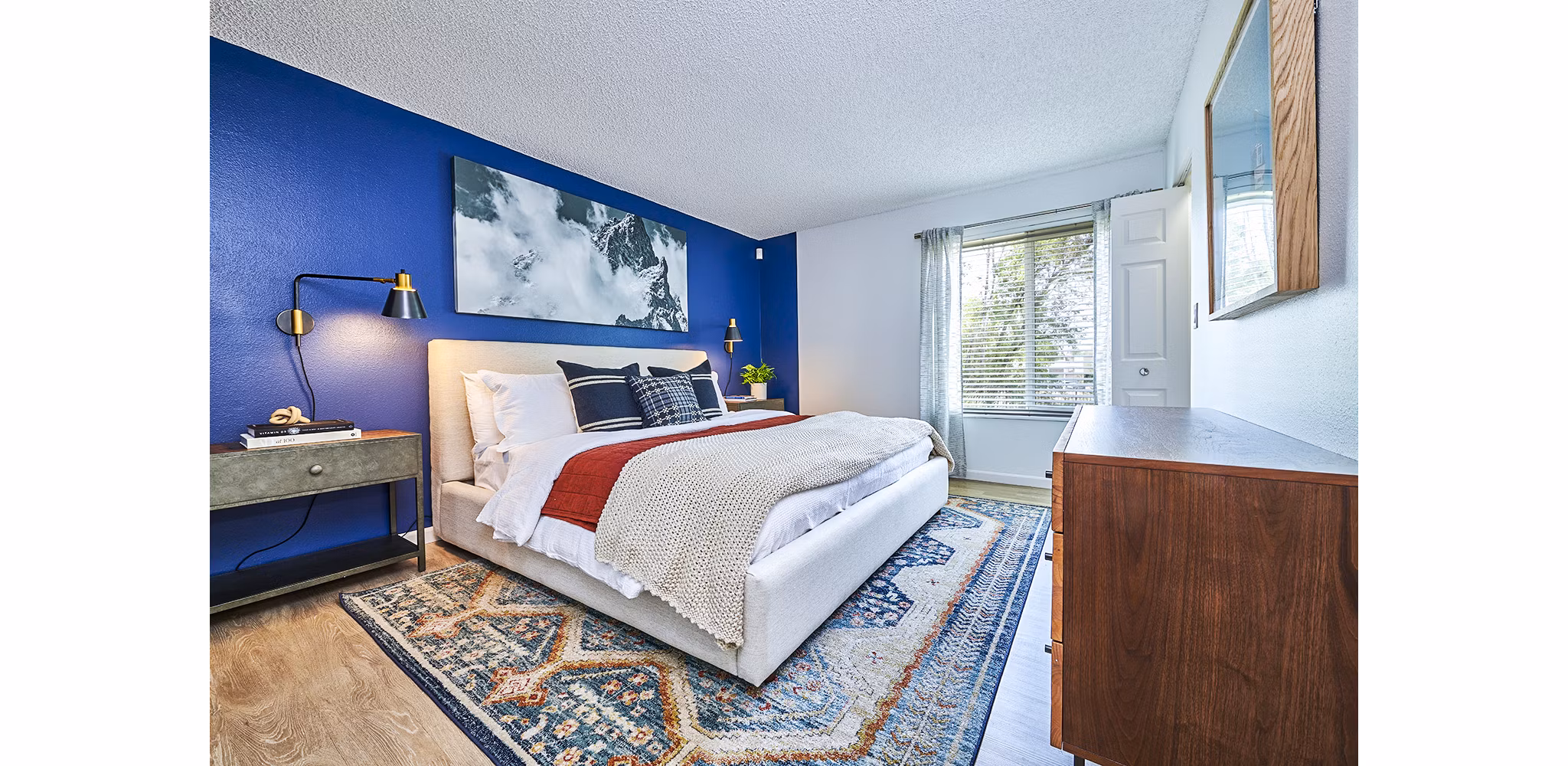 Spacious bedroom featuring large windows and modern decor at Greenwood Point Apartments