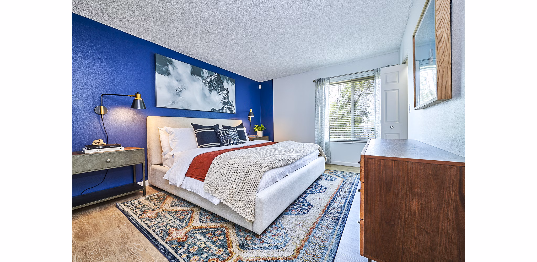 Spacious bedroom featuring large windows and modern decor at Greenwood Point Apartments