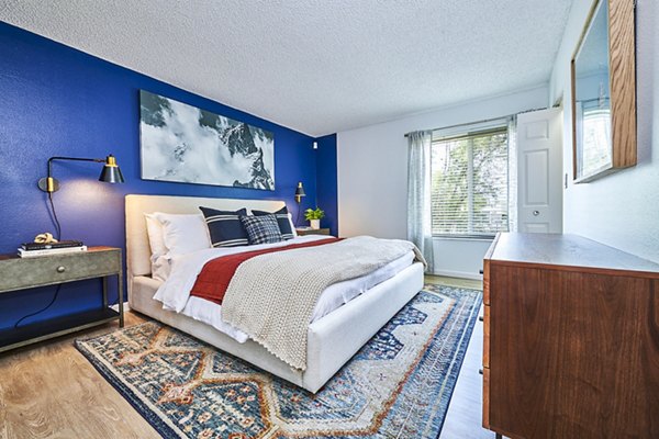 Spacious bedroom featuring large windows and modern decor at Greenwood Point Apartments