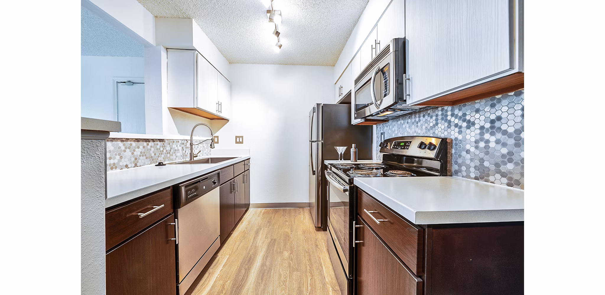 Contemporary kitchen with stainless steel appliances in Greenwood Point Apartments