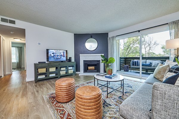 Living room featuring modern design and cozy seating in Greenwood Point Apartments