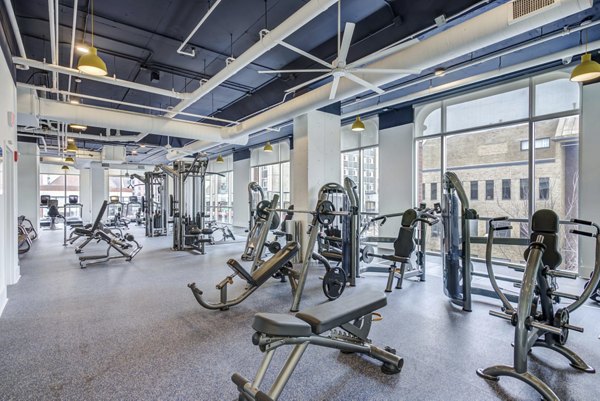 Fitness center with modern equipment at Landmark Apartments featuring cardio machines and weight stations