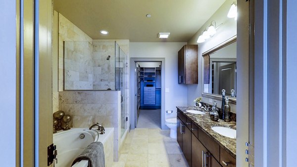 Modern bathroom with marble countertops in The Olivian Apartments