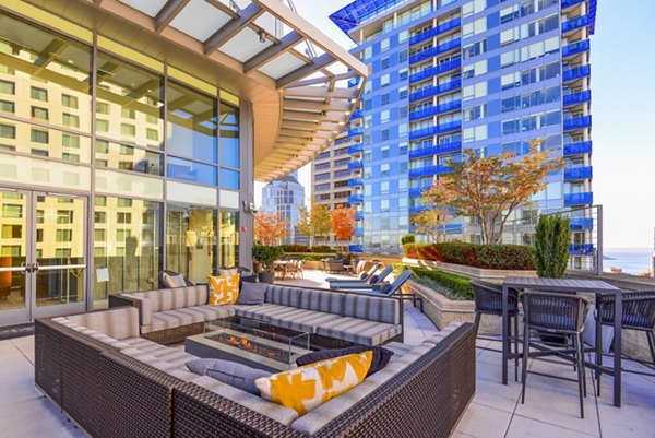 Cozy fire pit on a furnished patio at The Olivian Apartments in a luxury setting, offering residents a warm, relaxing outdoor environment