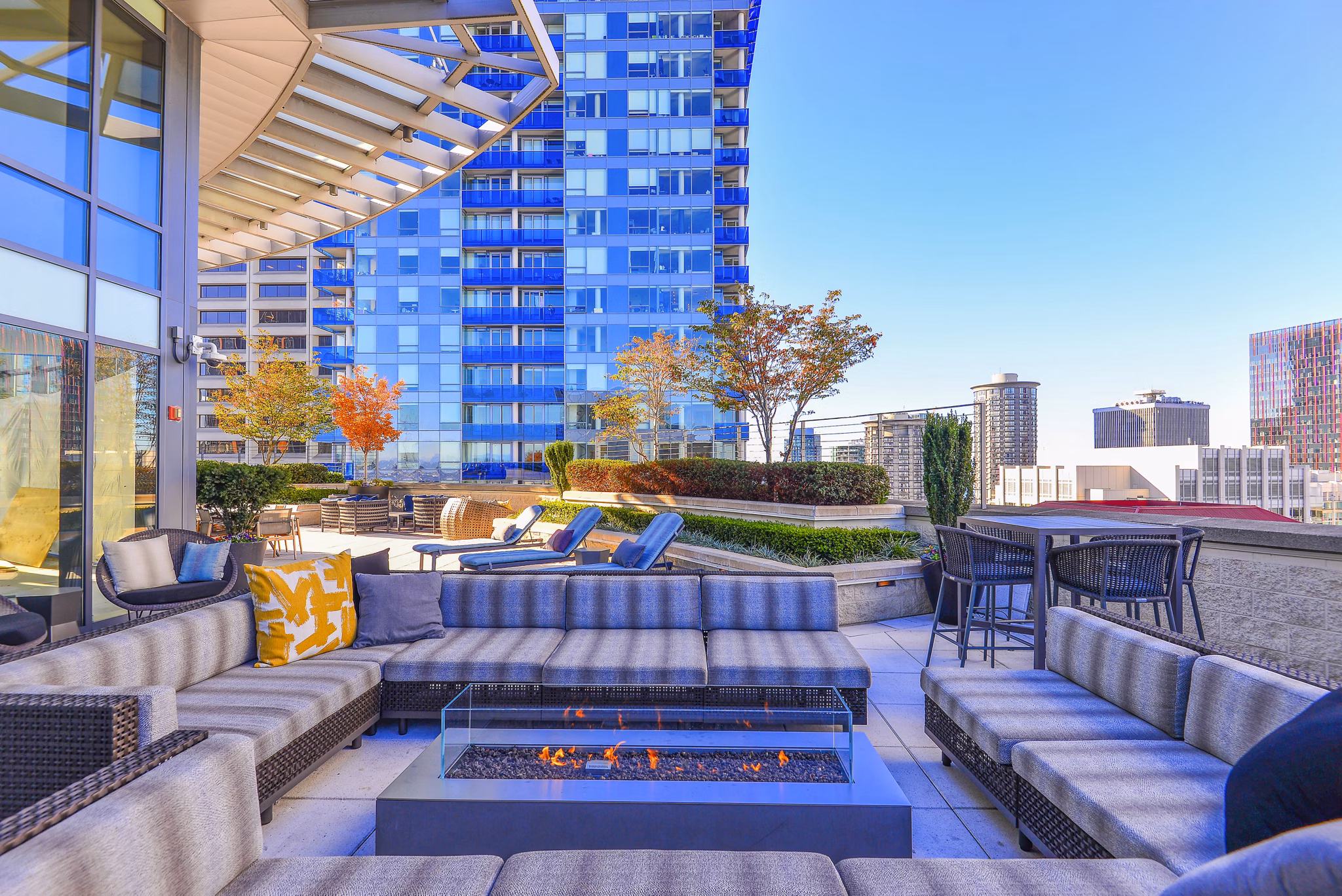 Fire pit and cozy seating area on the patio at The Olivian Apartments