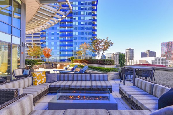 Fire pit and cozy seating area on the patio at The Olivian Apartments