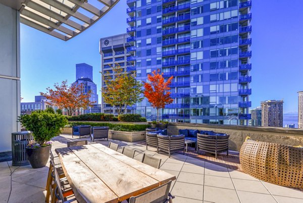 Elegant outdoor patio with city view at The Olivian Apartments, offering luxury living spaces in vibrant urban setting