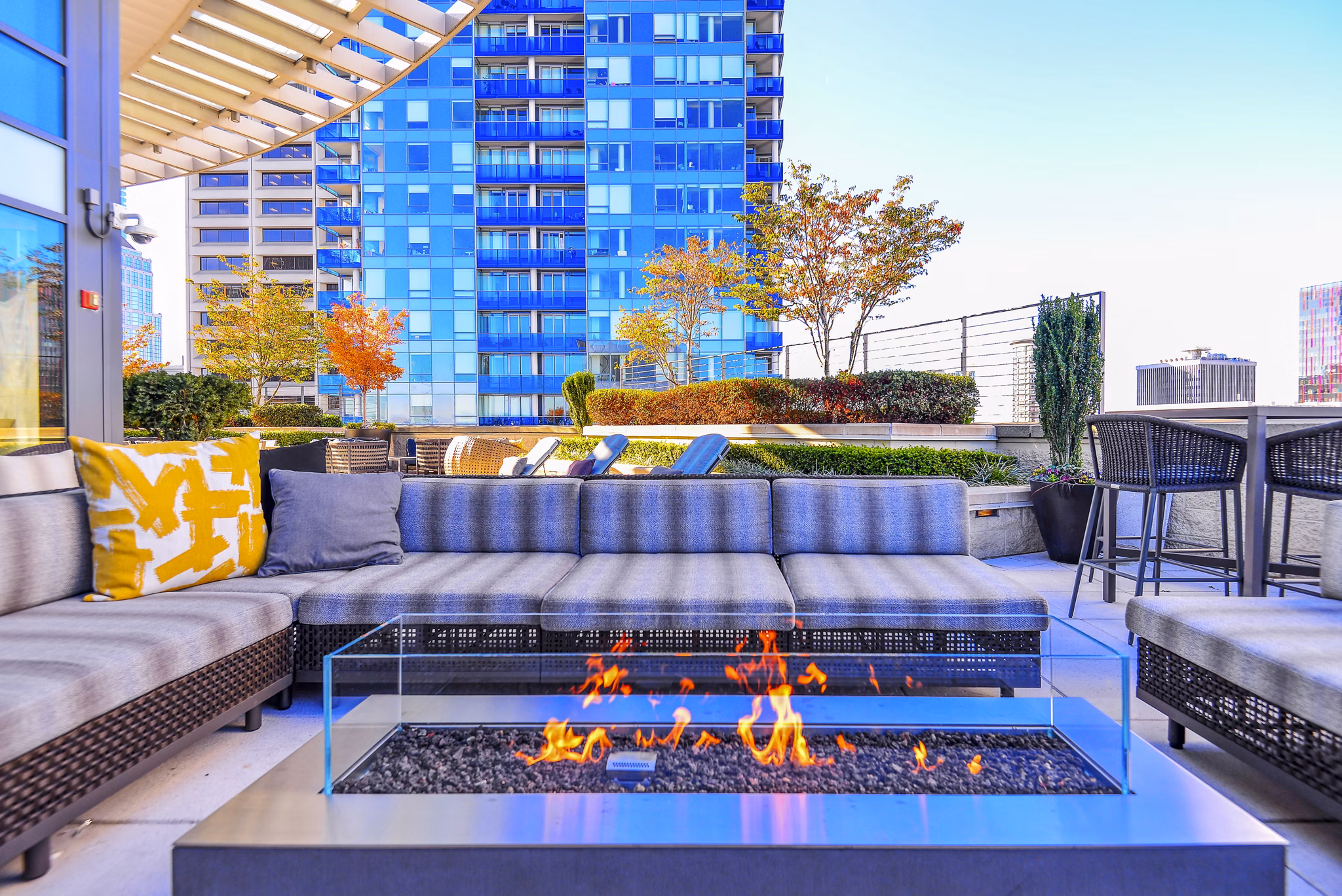 Cozy fire pit on outdoor patio at The Olivian Apartments, perfect for relaxation and social gatherings in a luxury setting