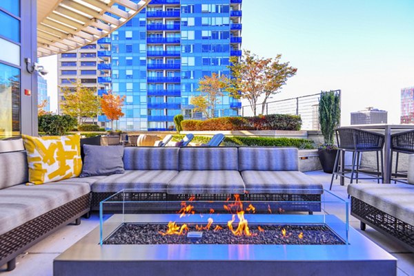 Cozy fire pit on outdoor patio at The Olivian Apartments, perfect for relaxation and social gatherings in a luxury setting