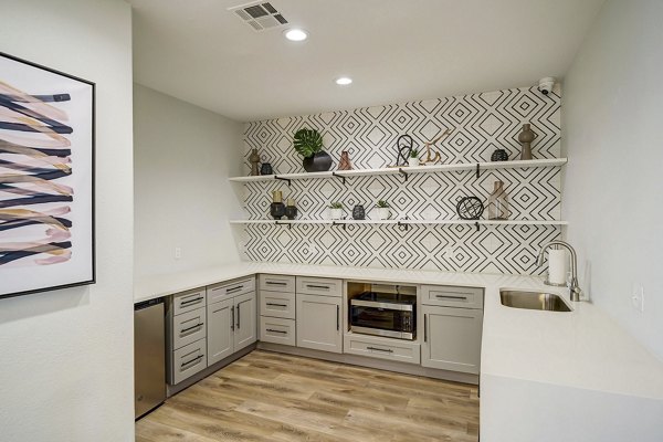 Modern kitchen with stainless steel appliances and island in Artemis at Spring Canyon Apartments