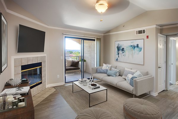 Spacious living room with modern decor at Artemis at Spring Canyon Apartments