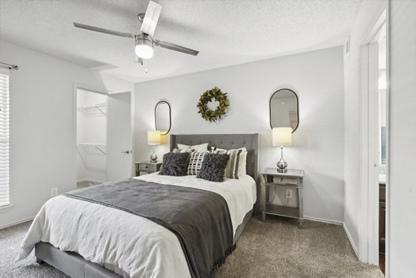 Bedroom featuring elegant furnishings and a large window in Townlake of Coppell Apartments