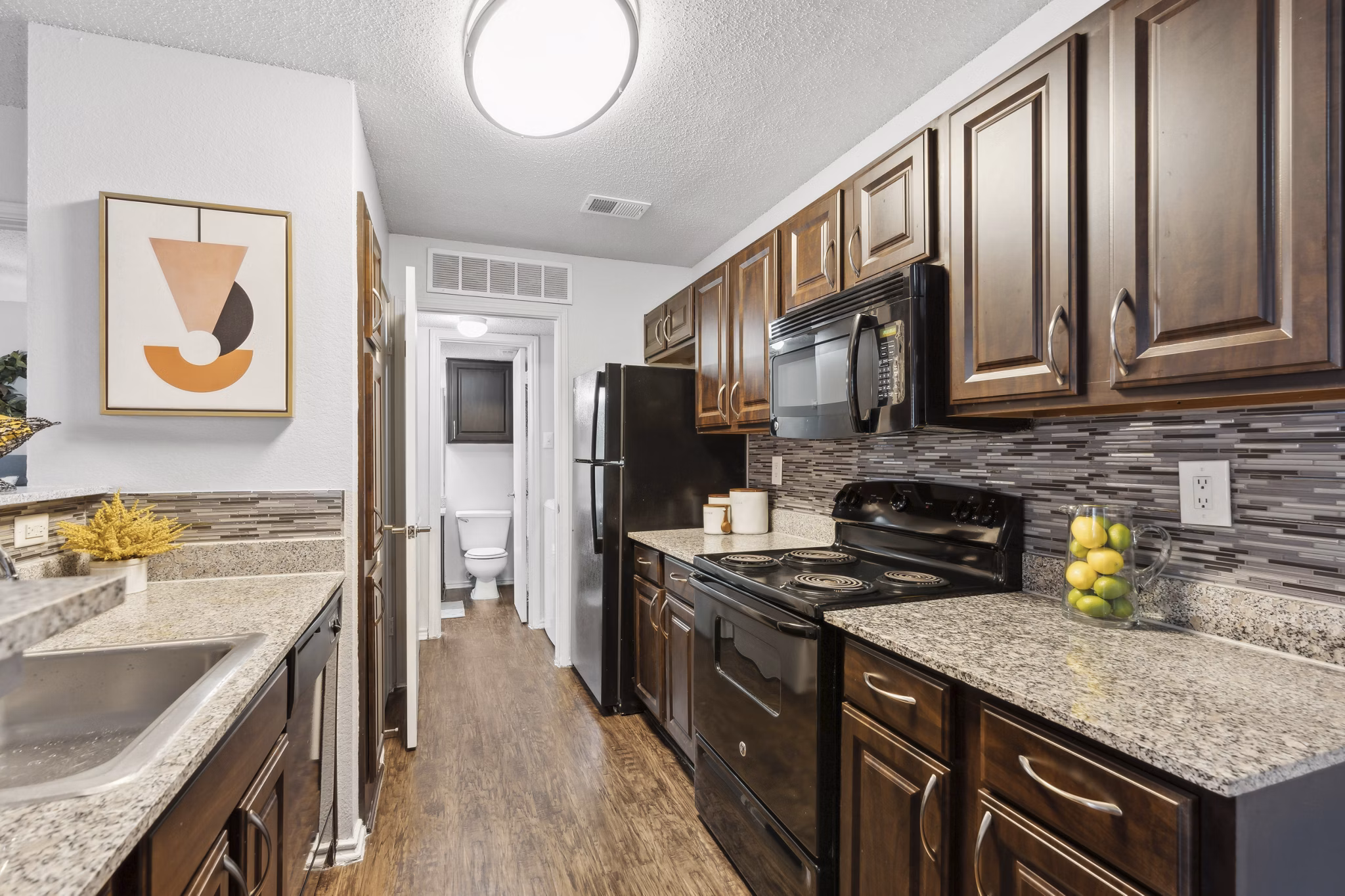 Contemporary kitchen with stainless steel appliances at Townlake of Coppell Apartments