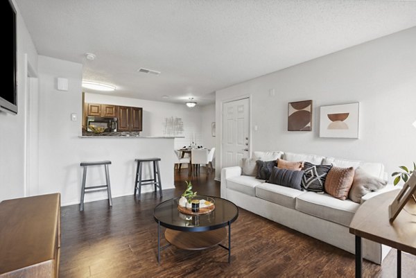 Living room featuring cozy seating and modern decor in Townlake of Coppell Apartments
