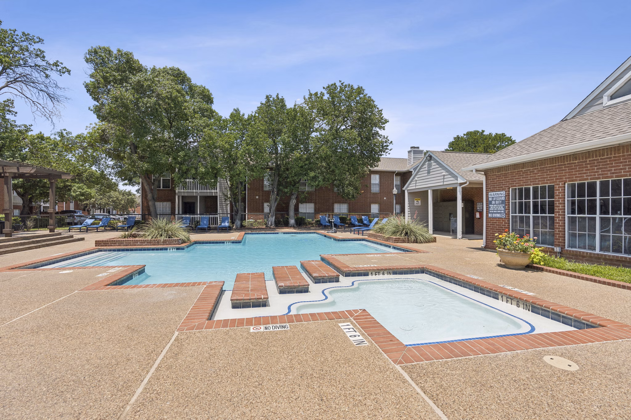 Poolside oasis with resort-style lounging at Townlake of Coppell Apartments