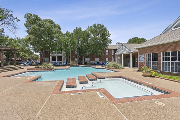 Poolside oasis with resort-style lounging at Townlake of Coppell Apartments