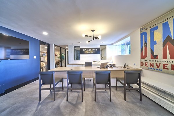 Modern office reception area with desk and wall-mounted TV at Cambridge Place luxury apartments