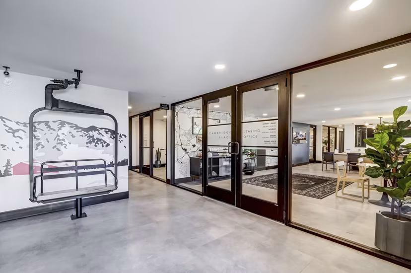 Modern office space featuring a long table, chairs, and stylish pendant lights in luxury apartments