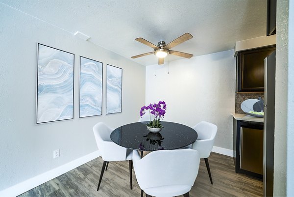 Dining room with elegant dining set and natural light at Cambridge Place Apartments