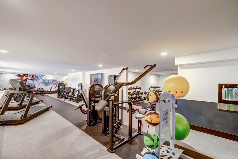 Fitness center featuring treadmills, exercise bikes, and weight machines at luxury apartments