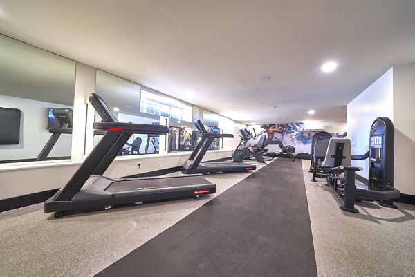 Fitness center featuring treadmills, exercise bikes, and weight machines at luxury apartments