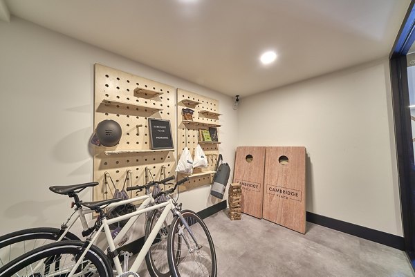 Activity room featuring bikes and cornhole boards at luxury apartments