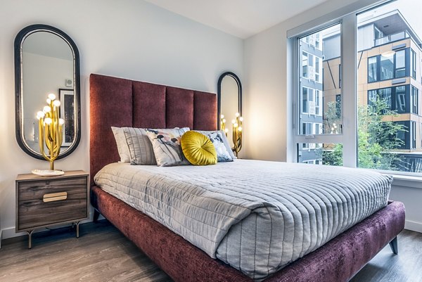 Cozy bedroom with modern decor in Jackson Apartments, featuring stylish furniture and large windows