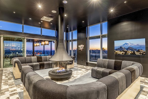Clubhouse featuring modern lounge seating and large TV at Jackson Apartments