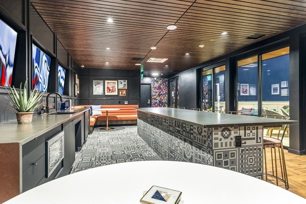 Clubhouse featuring modern design and communal seating areas at Jackson Apartments